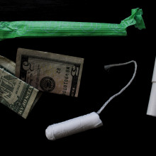 photograph of a tampon and some dollars